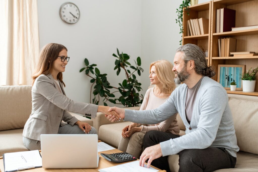 casual-bearded-man-shaking-hand-of-young-female-real-estate-agent-over-desk.jpg
